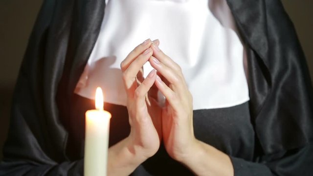 nun undressing and stroking her breasts. close-up. tempted