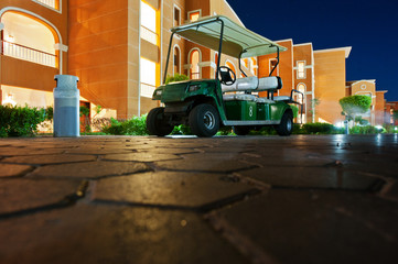 Golf car at resort on night. Down view
