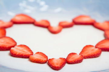 Beautiful heart symbol from chopped red juicy strawberry