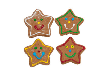 Fototapeta na wymiar Smiling star shaped Christmas gingerbread cookies on white background