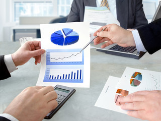 Closeup of hands with financial  charts  at business meeting in the office
