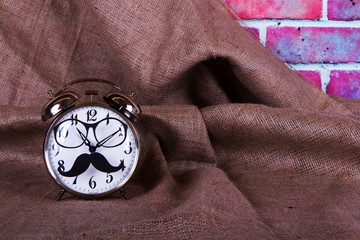 Alarm clock with a black hipster mustache