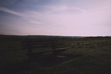 Empty bench over looking the countryside from Bude, Cornwall Vin