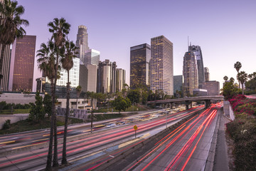 Naklejka premium Downtown Los Angeles at sunset with light trails