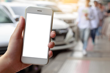 Woman hand holding smartphone isolated white screen with car on road  background
