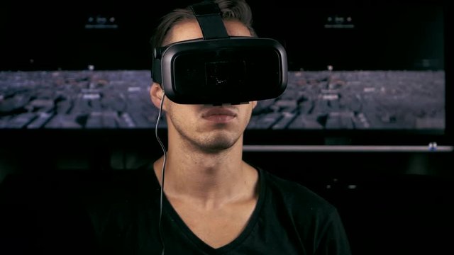 Close-up man put on VR-headset and getting experience in using VR-headset.