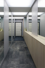 Interior of a hall with many mirrors and an entrance door