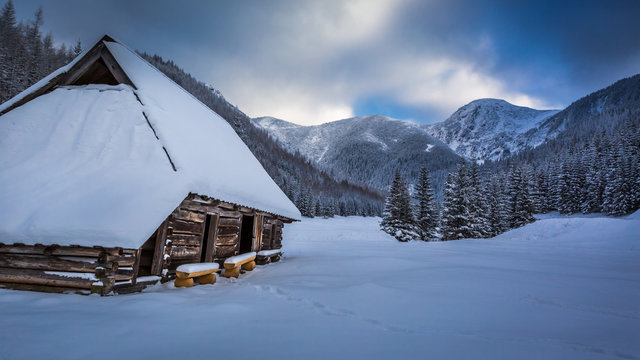 Old wooden cottages in winter mountains, Poland
