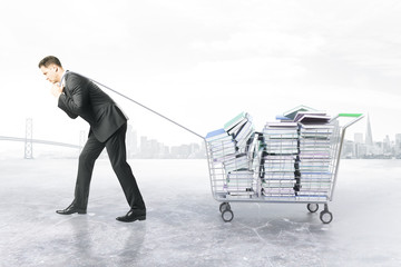 Man dragging trolley with books