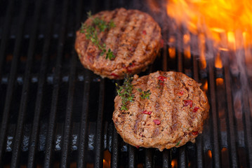  burgers on party summer barbecue grill with flame.