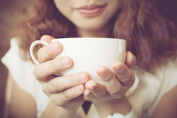 Closeup young girl smiling happy drinking coffee