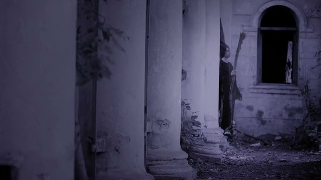 horned witch ghost walks through the ruins of the castle. halloween Horror