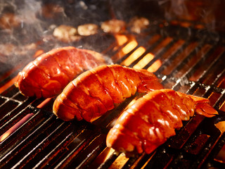 Lobster tails cooking on grill
