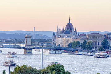 Budapest Parliament Building at Sunset with Boats and Bridges