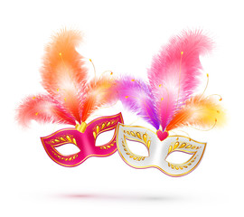 Pair of bright vector carnival masks with colorful feathers