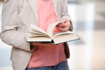 Young student reading book in preparation for exams