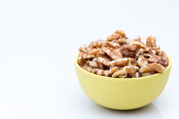 Bowl of walnuts on a white background.