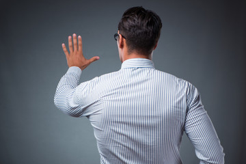 Handsome businessman pressing virtual buttons