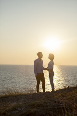 silhouette photography of couples younger man and woman standing
