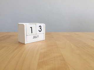 July 13th.July 13 white wooden calendar on vintage wood abstract