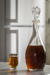 The decanter of brandy and a glass