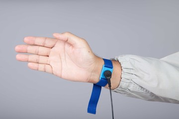 Ground bracelet on man hand  wearing ESD cloth isolated on gray