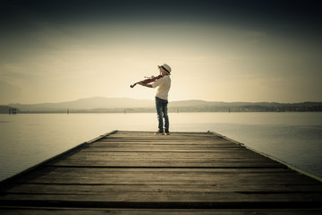 adorable boy playing the violin