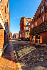 Cobblestone street and old brick buildings in the waterfront area