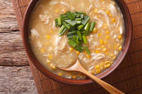 Chinese food: corn soup with chicken and onions close-up. horizontal top view
