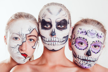 Three girls with Halloween face art on white background