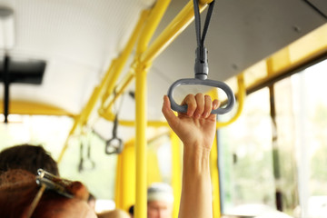 Naklejka premium Hand holding handle on the public transport