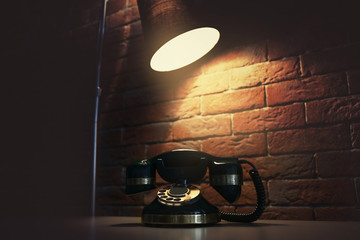 Old telephone on the table in dark room