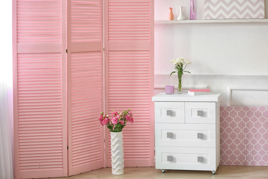 Light room interior with pink folding screen