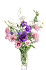 Obraz na płótnie Canvas bunch of violet, white and pink eustoma flowers in glass vase is
