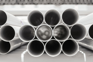 PVC pipes stacked in warehouse.