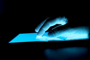 ighlighted in blue tablet screen and navigating hand