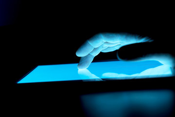 ighlighted in blue tablet screen and navigating hand