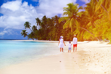 family with child walking on beach