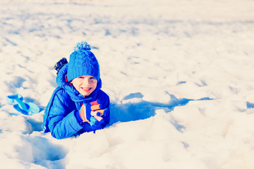 happy little boy having fun in winter snow