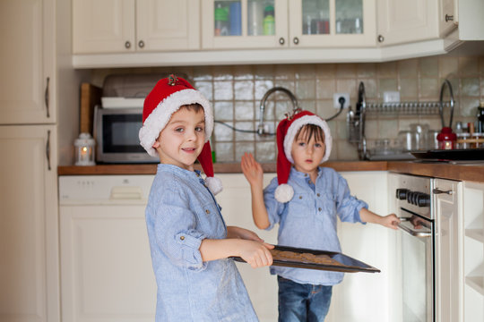Sweet little children, boy brothers, preparing ginger bread cook