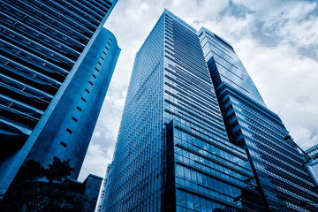 Fototapeta na wymiar low angle view of modern metallic skyscrapers,blue toned,suzhou,china.