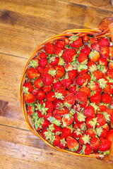 Lot of strawberries on the table in basket. View from above.