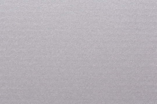 Embossed white paper with paralel lines pattern.
