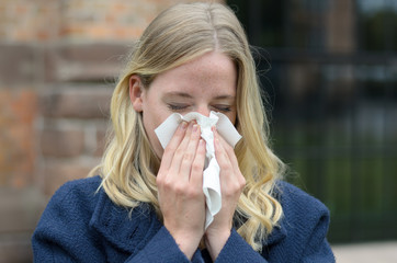 Young woman suffering from a seasonal cold