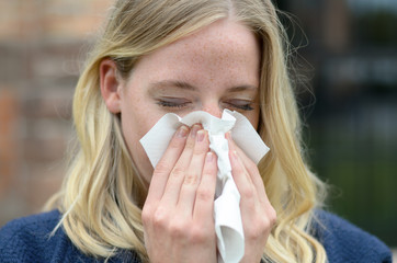 Young woman suffering from a seasonal cold
