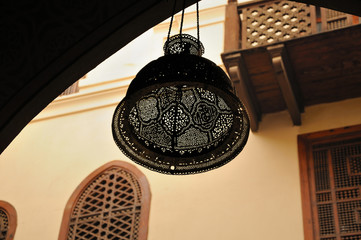 ancient medieval mediterranean lamp under the ceiling of an arch in a fortress