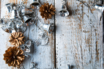 Silver christmas tree bells on white wooden background. Copyspace