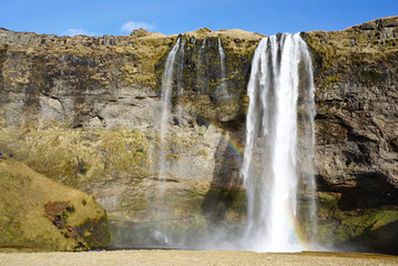 Beautiful  Seljalandsfoss waterfall with river and meadow