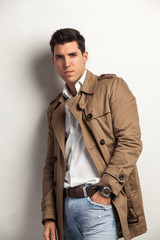 young attractive man in a trench rain coat