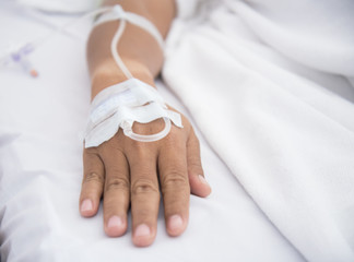 Close up of a patient in hospital with saline intravenous (iv), select focus